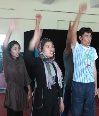 Power to the people! Actually Roya, Halimeh and Gulam Reza are shouting "I like chocolate"!