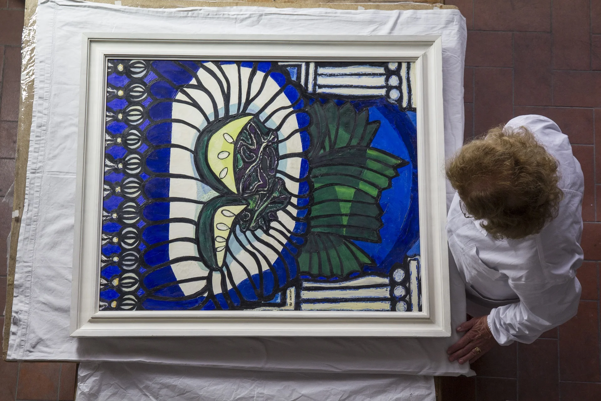 Conservator Rossella Lari contemplates a still-life work by Cuban artist Amelia Palaez.
Normal
0
14
false
false
false
IT
X-NONE
X-NONE
/* Style Definitions */
table.MsoNormalTable
{mso-style-name:"Tabella normale";
mso-tstyle-rowband-size:0;
mso-tstyle-colband-size:0;
mso-style-noshow:yes;
mso-style-priority:99;
mso-style-qformat:yes;
mso-style-parent:"";
mso-padding-alt:0cm 5.4pt 0cm 5.4pt;
mso-para-margin-top:0cm;
mso-para-margin-right:0cm;
mso-para-margin-bottom:10.0pt;
mso-para-margin-left:0cm;
line-height:115%;
mso-pagination:widow-orphan;
font-size:11.0pt;
font-family:"Calibri","sans-serif";
mso-ascii-font-family:Calibri;
mso-ascii-theme-font:minor-latin;
mso-fareast-font-family:"Times New Roman";
mso-fareast-theme-font:minor-fareast;
mso-hansi-font-family:Calibri;
mso-hansi-theme-font:minor-latin;}
Normal
0
14
false
false
false
IT
X-NONE
X-NONE
/* Style Definitions */
table.MsoNormalTable
{mso-style-name:"Tabella normale";
mso-tstyle-rowband-size:0;
mso-tstyle-colband-size:0;
mso-style-noshow:yes;
mso-style-priority:99;
mso-style-qformat:yes;
mso-style-parent:"";
mso-padding-alt:0cm 5.4pt 0cm 5.4pt;
mso-para-margin-top:0cm;
mso-para-margin-right:0cm;
mso-para-margin-bottom:10.0pt;
mso-para-margin-left:0cm;
line-height:115%;
mso-pagination:widow-orphan;
font-size:11.0pt;
font-family:"Calibri","sans-serif";
mso-ascii-font-family:Calibri;
mso-ascii-theme-font:minor-latin;
mso-fareast-font-family:"Times New Roman";
mso-fareast-theme-font:minor-fareast;
mso-hansi-font-family:Calibri;
mso-hansi-theme-font:minor-latin;}
Normal
0
14
false
false
false
IT
X-NONE
X-NONE
/* Style Definitions */
table.MsoNormalTable
{mso-style-name:"Tabella normale";
mso-tstyle-rowband-size:0;
mso-tstyle-colband-size:0;
mso-style-noshow:yes;
mso-style-priority:99;
mso-style-qformat:yes;
mso-style-parent:"";
mso-padding-alt:0cm 5.4pt 0cm 5.4pt;
mso-para-margin-top:0cm;
mso-para-margin-right:0cm;
mso-para-margin-bottom:10.0pt;
mso-para-margin-left:0cm;
line-height:115%;
mso-pagination:widow-orphan;
font-size:11.0pt;
font-family:"Calibri","sans-serif";
mso-ascii-font-family:Calibri;
mso-ascii-theme-font:minor-latin;
mso-fareast-font-family:"Times New Roman";
mso-fareast-theme-font:minor-fareast;
mso-hansi-font-family:Calibri;
mso-hansi-theme-font:minor-latin;}
Normal
0
14
false
false
false
IT
X-NONE
X-NONE
/* Style Definitions */
table.MsoNormalTable
{mso-style-name:"Tabella normale";
mso-tstyle-rowband-size:0;
mso-tstyle-colband-size:0;
mso-style-noshow:yes;
mso-style-priority:99;
mso-style-qformat:yes;
mso-style-parent:"";
mso-padding-alt:0cm 5.4pt 0cm 5.4pt;
mso-para-margin-top:0cm;
mso-para-margin-right:0cm;
mso-para-margin-bottom:10.0pt;
mso-para-margin-left:0cm;
line-height:115%;
mso-pagination:widow-orphan;
font-size:11.0pt;
font-family:"Calibri","sans-serif";
mso-ascii-font-family:Calibri;
mso-ascii-theme-font:minor-latin;
mso-fareast-font-family:"Times New Roman";
mso-fareast-theme-font:minor-fareast;
mso-hansi-font-family:Calibri;
mso-hansi-theme-font:minor-latin;}
Normal
0
14
false
false
false
IT
X-NONE
X-NONE
/* Style Definitions */
table.MsoNormalTable
{mso-style-name:"Tabella normale";
mso-tstyle-rowband-size:0;
mso-tstyle-colband-size:0;
mso-style-noshow:yes;
mso-style-priority:99;
mso-style-qformat:yes;
mso-style-parent:"";
mso-padding-alt:0cm 5.4pt 0cm 5.4pt;
mso-para-margin-top:0cm;
mso-para-margin-right:0cm;
mso-para-margin-bottom:10.0pt;
mso-para-margin-left:0cm;
line-height:115%;
mso-pagination:widow-orphan;
font-size:11.0pt;
font-family:"Calibri","sans-serif";
mso-ascii-font-family:Calibri;
mso-ascii-theme-font:minor-latin;
mso-fareast-font-family:"Times New Roman";
mso-fareast-theme-font:minor-fareast;
mso-hansi-font-family:Calibri;
mso-hansi-theme-font:minor-latin;}
