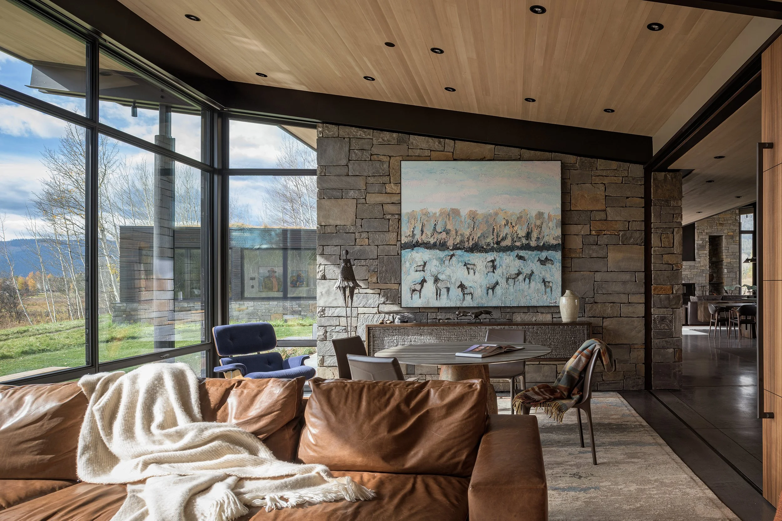 EK_Reedy_ChaChe_Residence_Interior_Media_Room_Open_to_Living_Mountain_Views_Stone_Concrete.jpg
