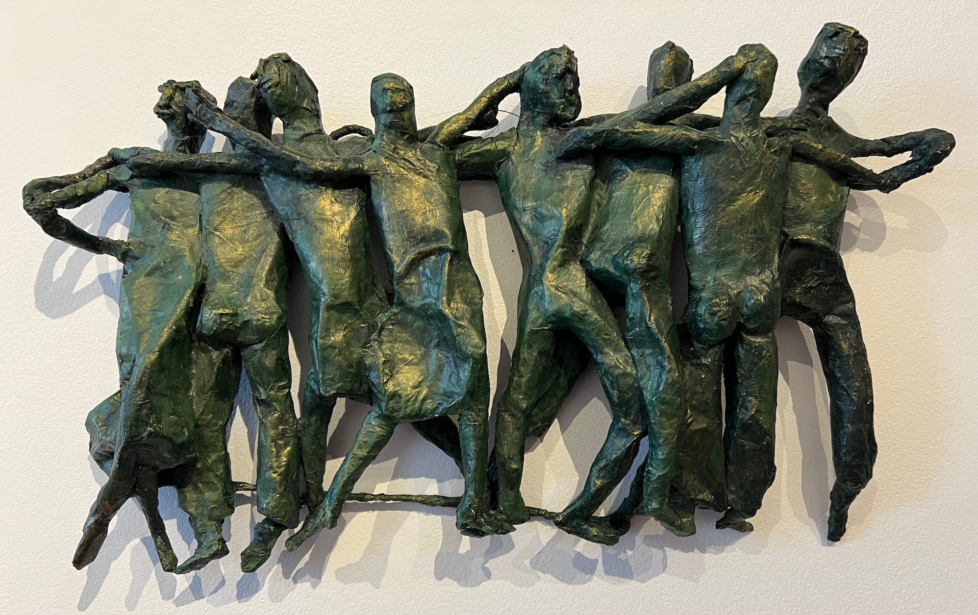 recycled paper sculpture of line dancers