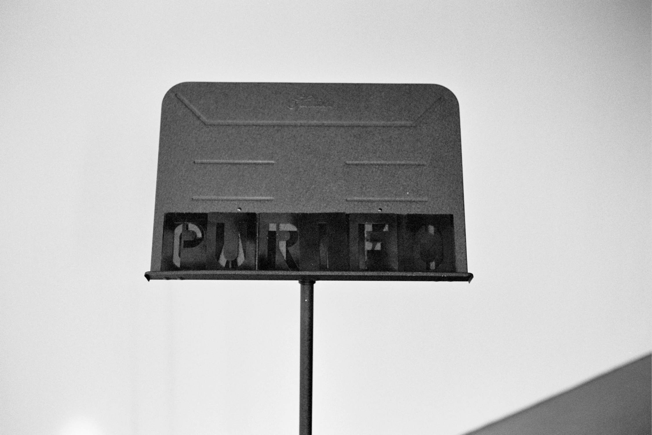 Keith O. Anderson “Purification, My Melody” 2013 Spray paint, stencil letters, and music stand, Dimensions variable