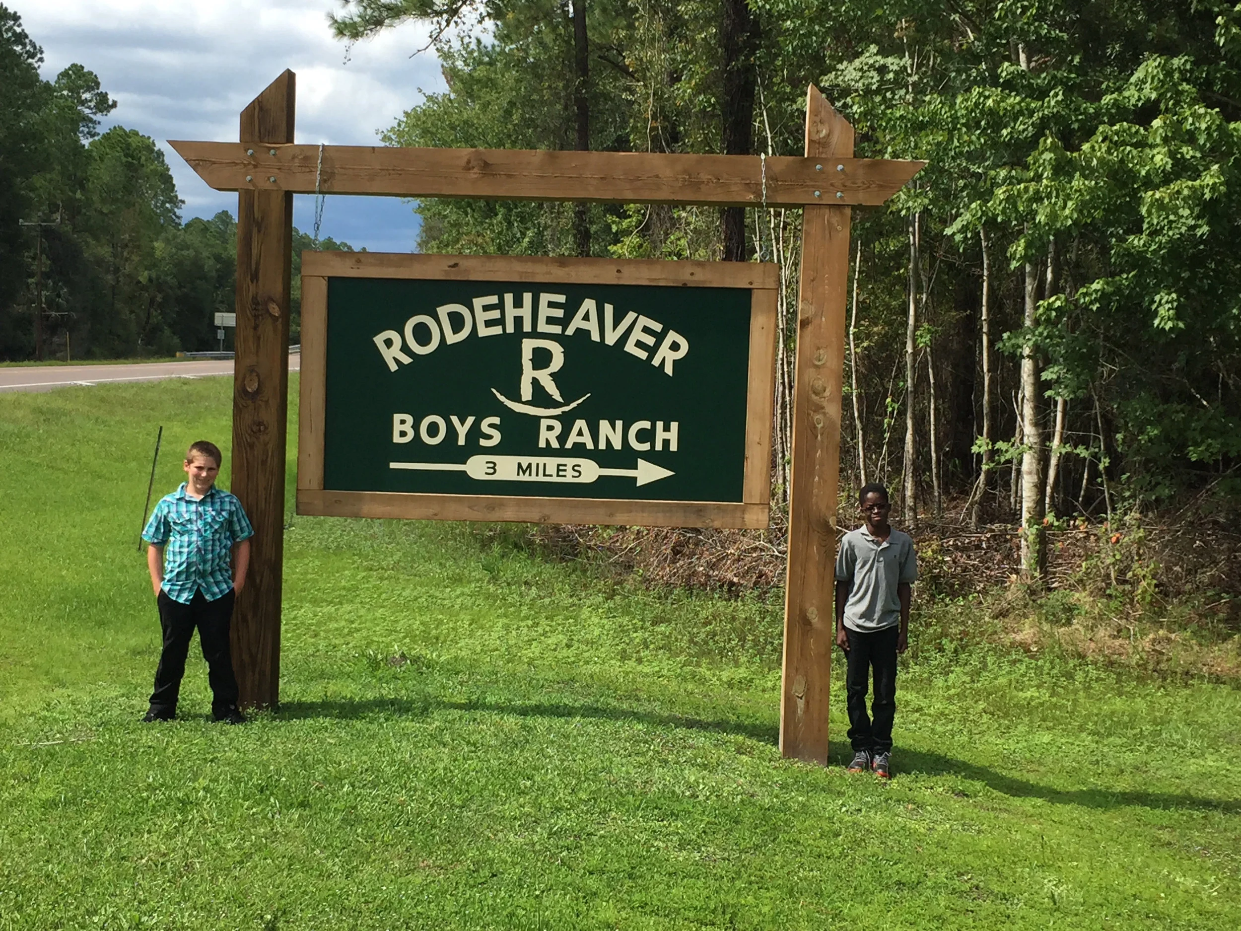 ranch sign with boys 3 mi.jpg