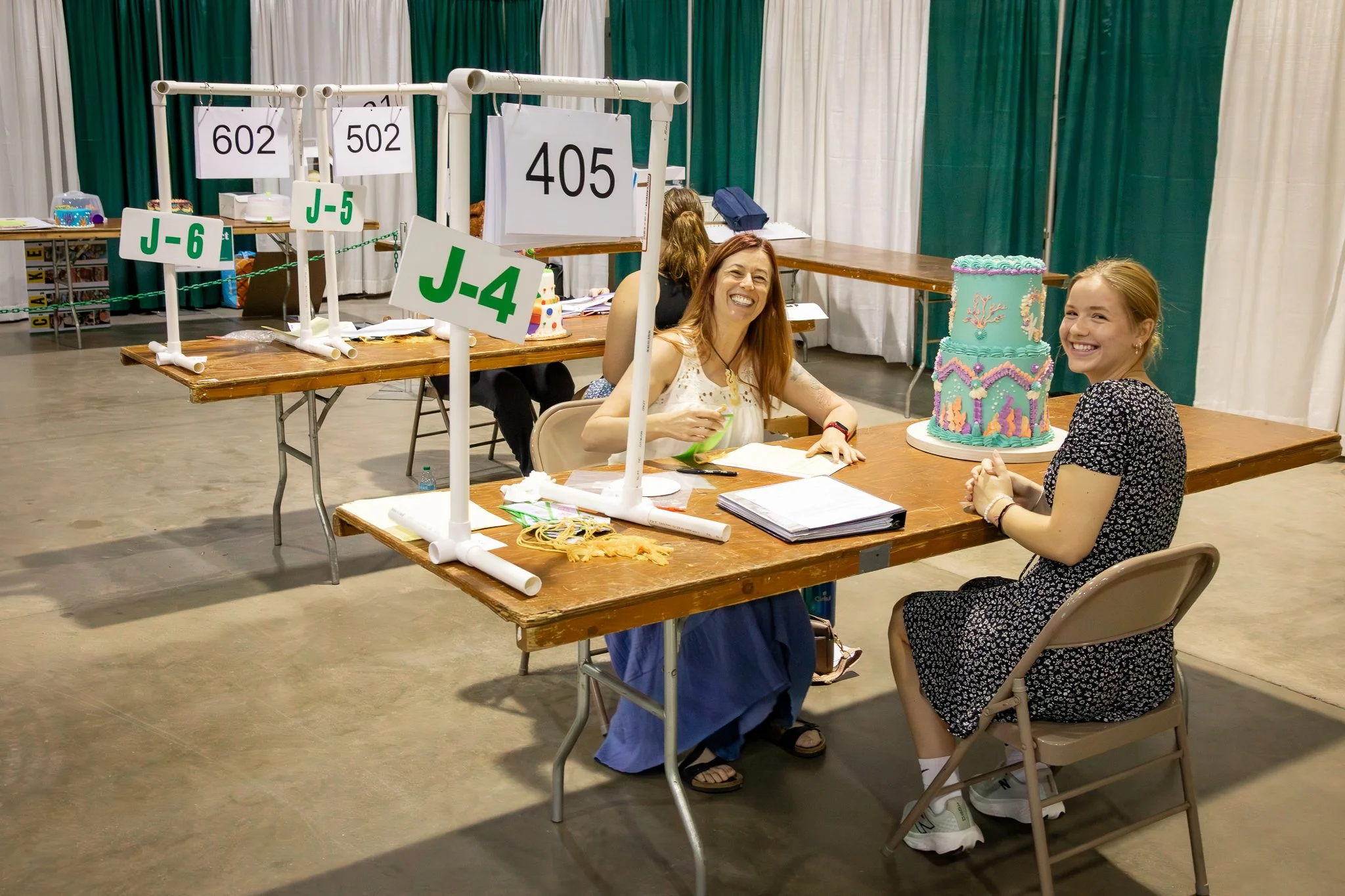 "Creative Arts Competition" 4H member Josi Flickinger from Perry County presents her cake. The Ohio State Fair. Thursday July 24, 2025.