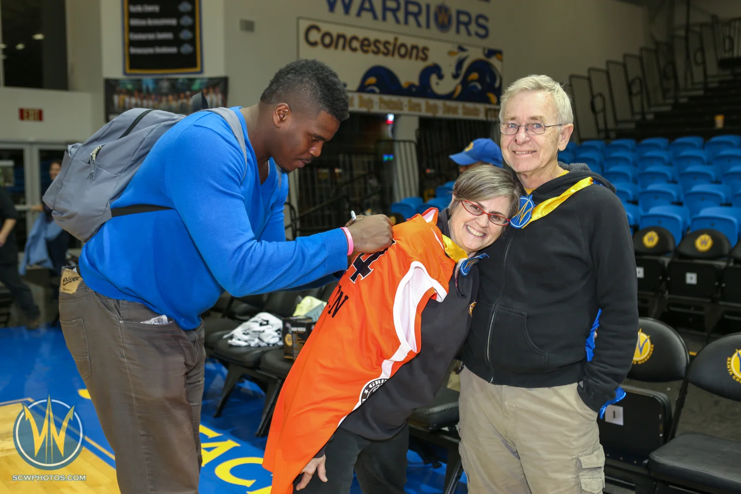 Fans get to pose with the player after winning the Jersey auction at the Santa Cruz Warriors game on February, 10, 2015 at Kaiser Permanente Arena in Santa Cruz, California. (Photo: Tim Cattera Photography/SC Warriors 2015)
