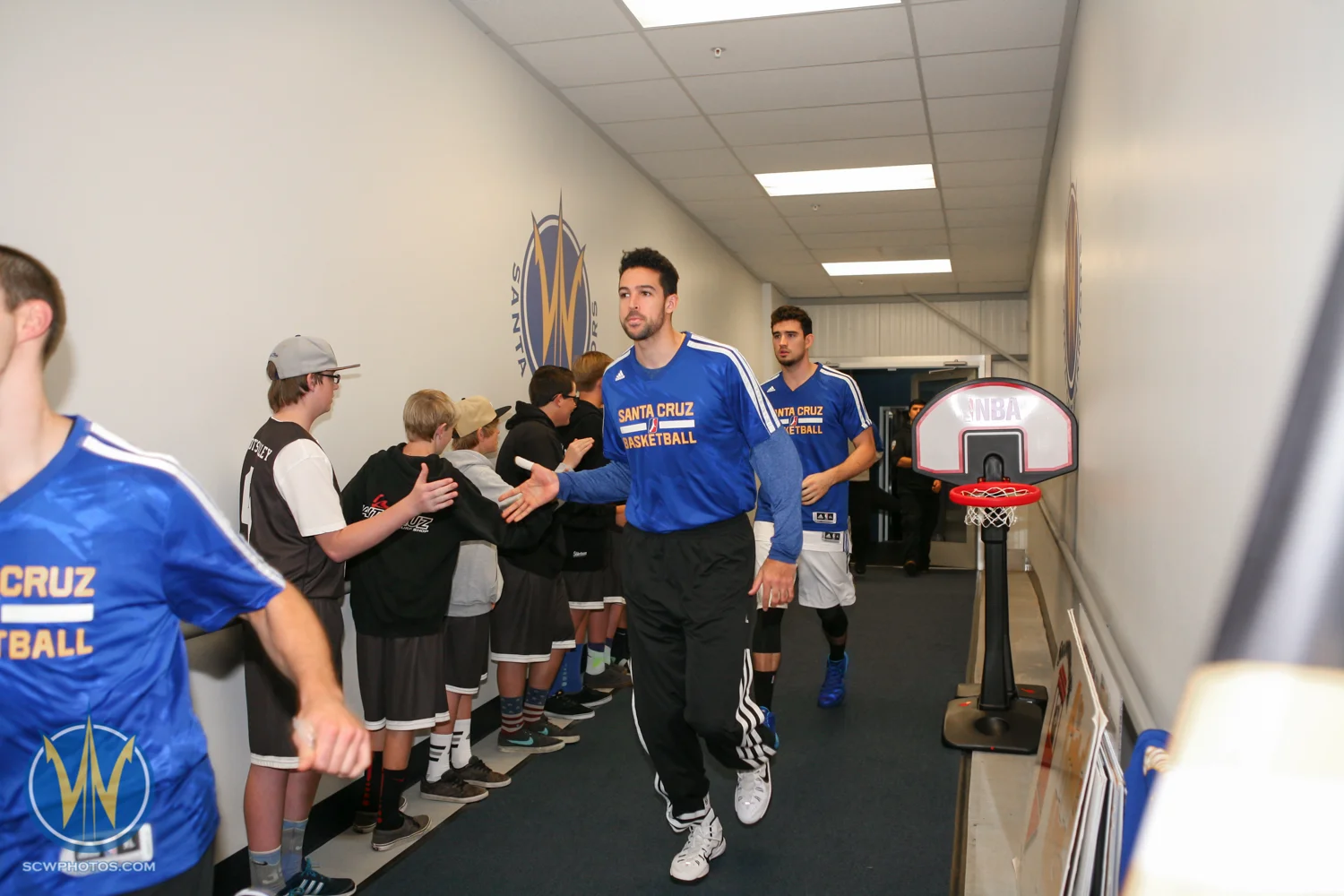 Mitchell Watt runs through the Fan Tunnel at the Santa Cruz Warriors game on November 30, 2014 at Kaiser Permanente Arena in Santa Cruz, California. (Photo: Tim Cattera Photography/SC Warriors 2014)