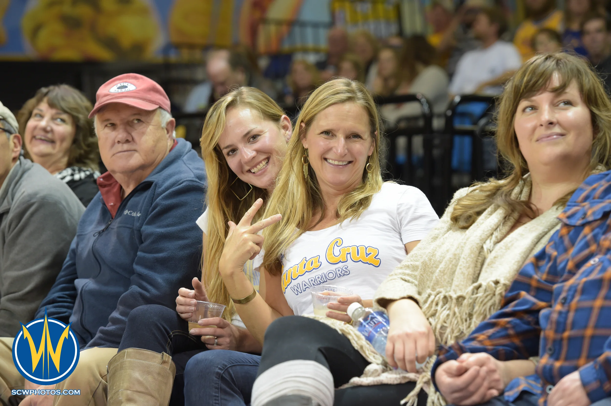 Warrior fans smiling for the camera at the Santa Cruz Warrior game on 1/23/16 at Kaiser Permanente Arena in Santa Cruz California. (Phil Pasag/SC Warriors 2015)