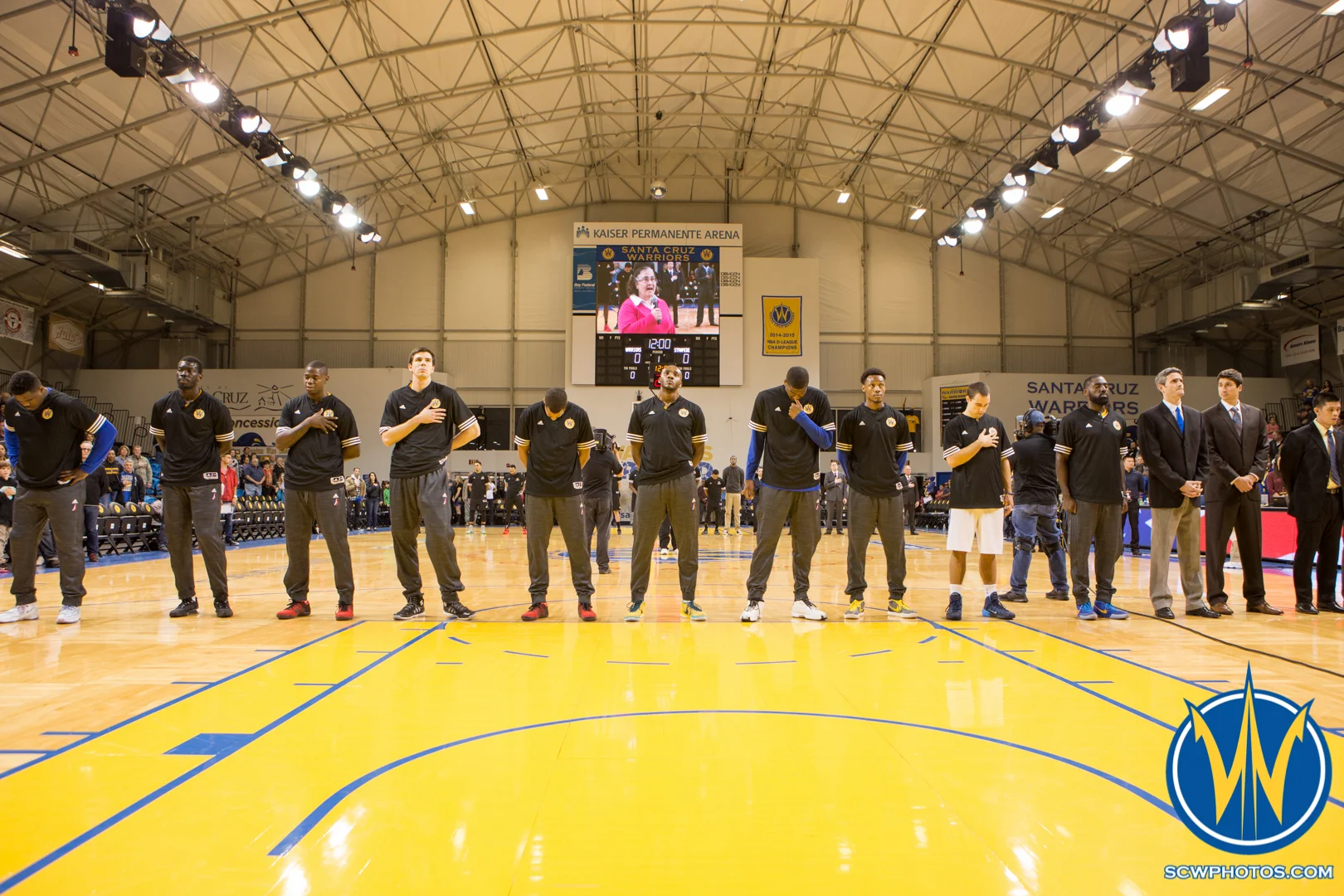Santa Cruz Warriors players stand while the National Anthem is performed at Kaiser Permanente Arena on January 20, 2016 (Photo: Ariel Nava Photography)