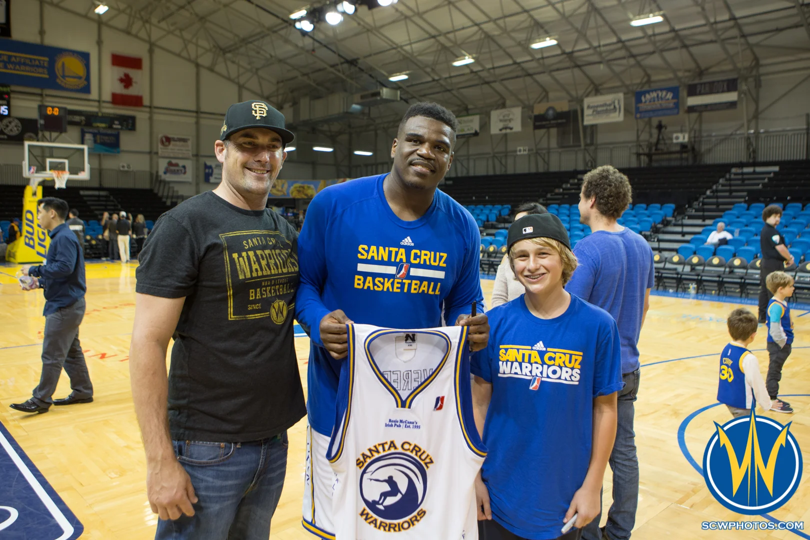 Anthony Vereen poses with the winners of his jersey which was auctioned off during the game at Kaiser Permanente Arena on February 26, 2016 (Photo: Ariel Nava Photography)
