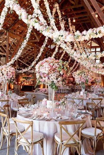 wedding-trends-2019-elegant-wedding-reception-in-barn-with-tall-centrpieces-pale-pink-flower-handing-garlang-larissaclevelandphoto-334x500.jpg