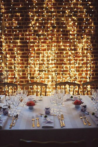 wedding-trends-2019-bridal-light-bulbs-arrangement-on-brick-loft-wall-elegant-reception-with-red-roses-cathy-dudzinski-photography-334x500.jpg
