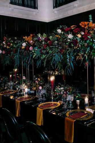 wedding-trends-2019-dark-mood-bridal-table-fall-colors-tall-orange-burgundy-greenery-flower-centerpieces-candles-camrynclairphoto-334x500.jpg