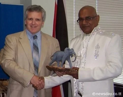 AWARD: US wildlife biologist DJ Schubert, left, presents the 2013 Clark R Bavin Wildlife Law Enforcement Award to retired Trinidad and Tobago game warden Samsundar Ramdeen on August 2 in New York .