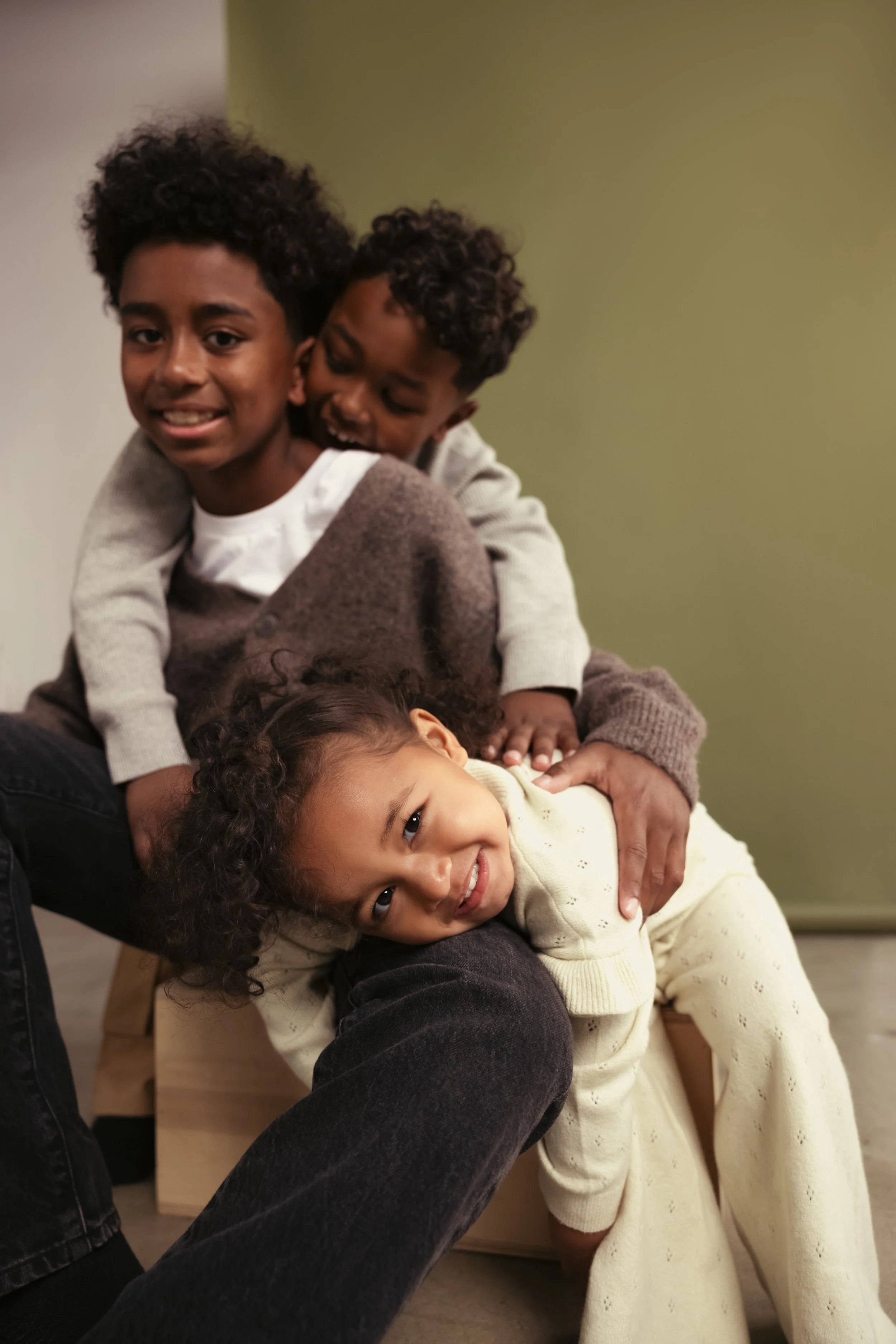 Three children play together. 