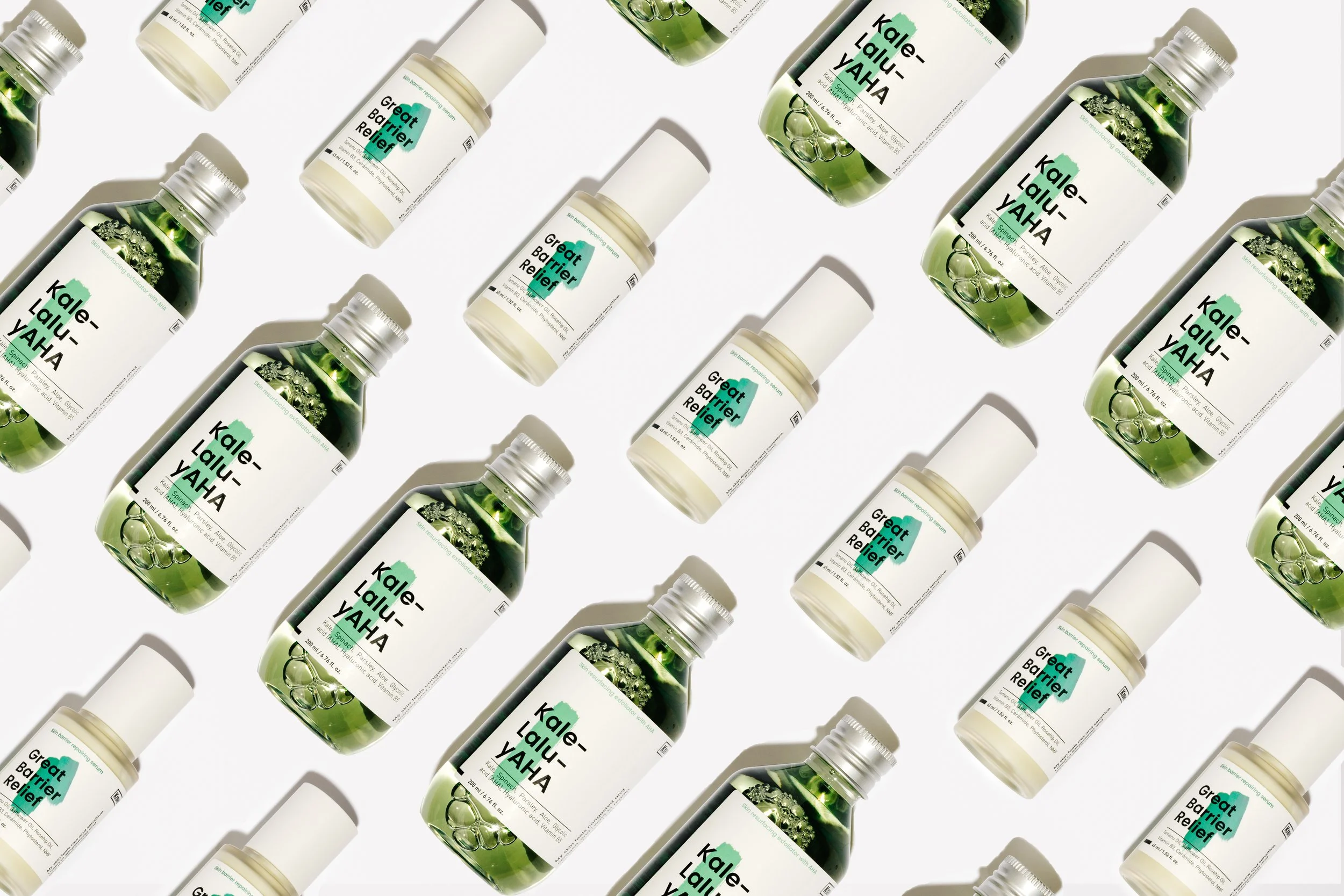 Multiple bottles of dietary supplement labeled 'Kale" with green liquid inside, arranged diagonally on a white background.