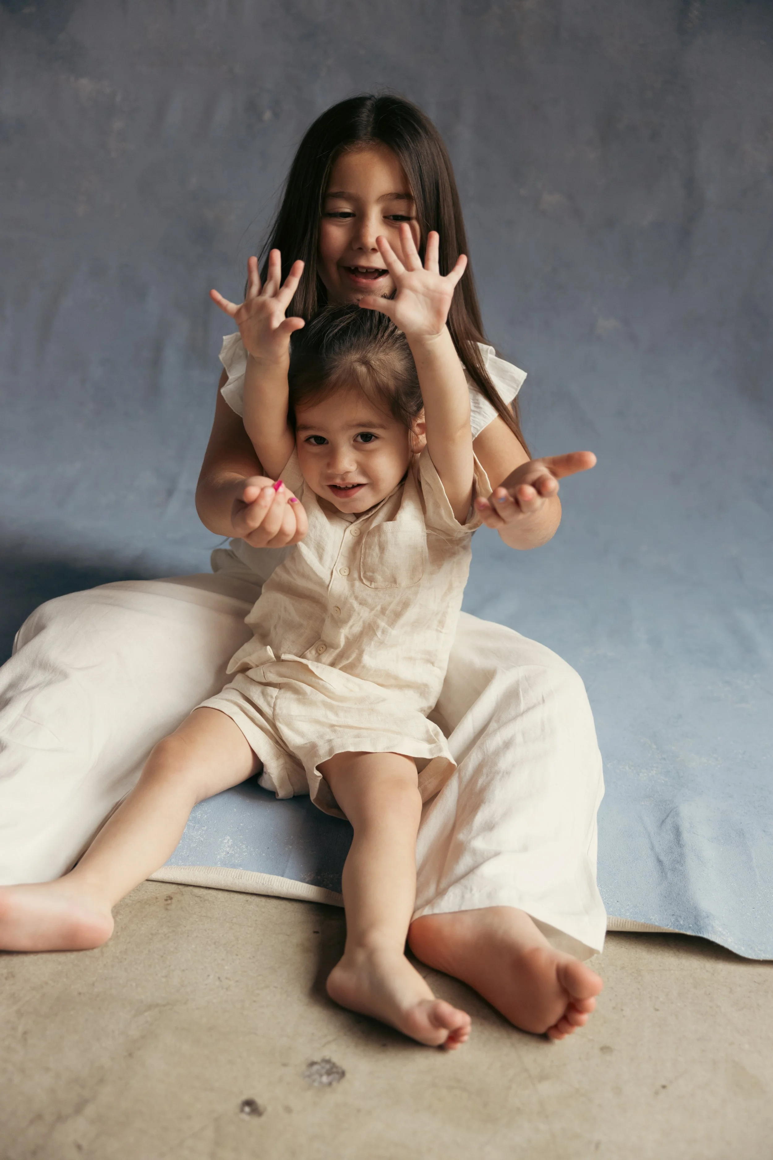 Fun candid family photographer in Los Angeles in studio, family photography. Fun Canvas painted backdrop in studio.