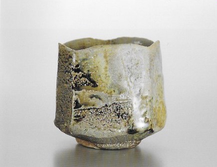 Ash glazed chawan (tea ceremony cup), with black and golden hues.