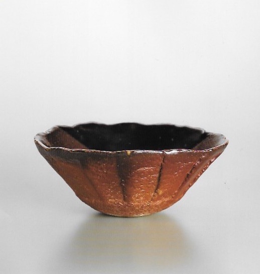 Fluted bowl in Nishihata's own deep red akadobe glaze. Nishihata was able to revive this ancient Tamba glaze, for which the methods to create it had long been lost, after 30 years of experimentation. 