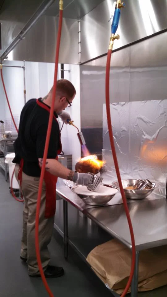 Hand glazing each ham