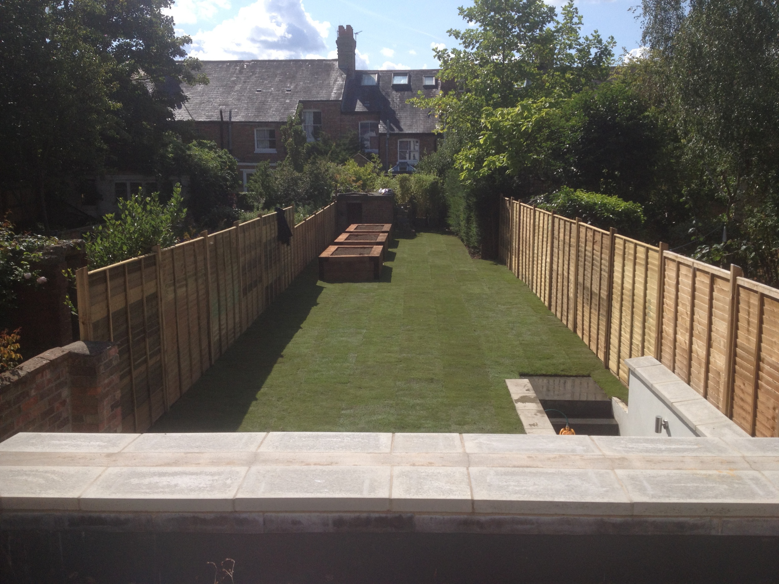 Raised beds, fencing, turf and paving