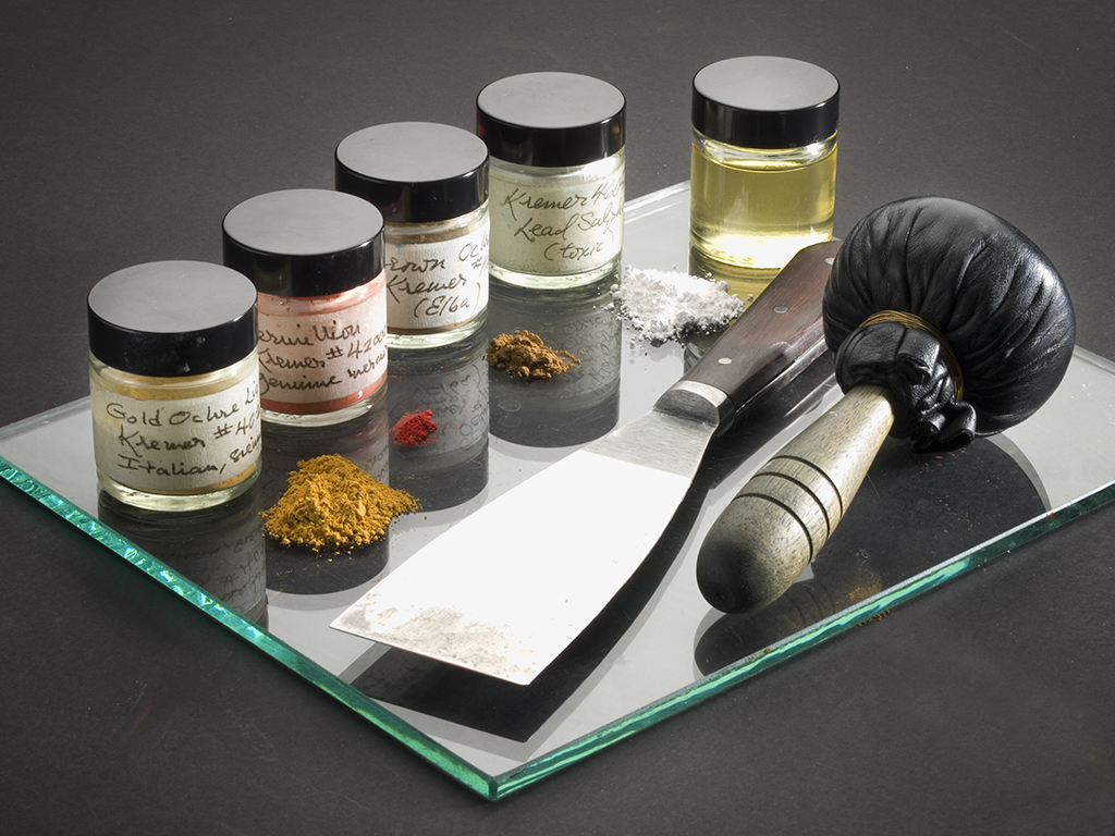 Historic pigments used to mix golden yellow ochre ink, shown with palette knife and leather ink dauber