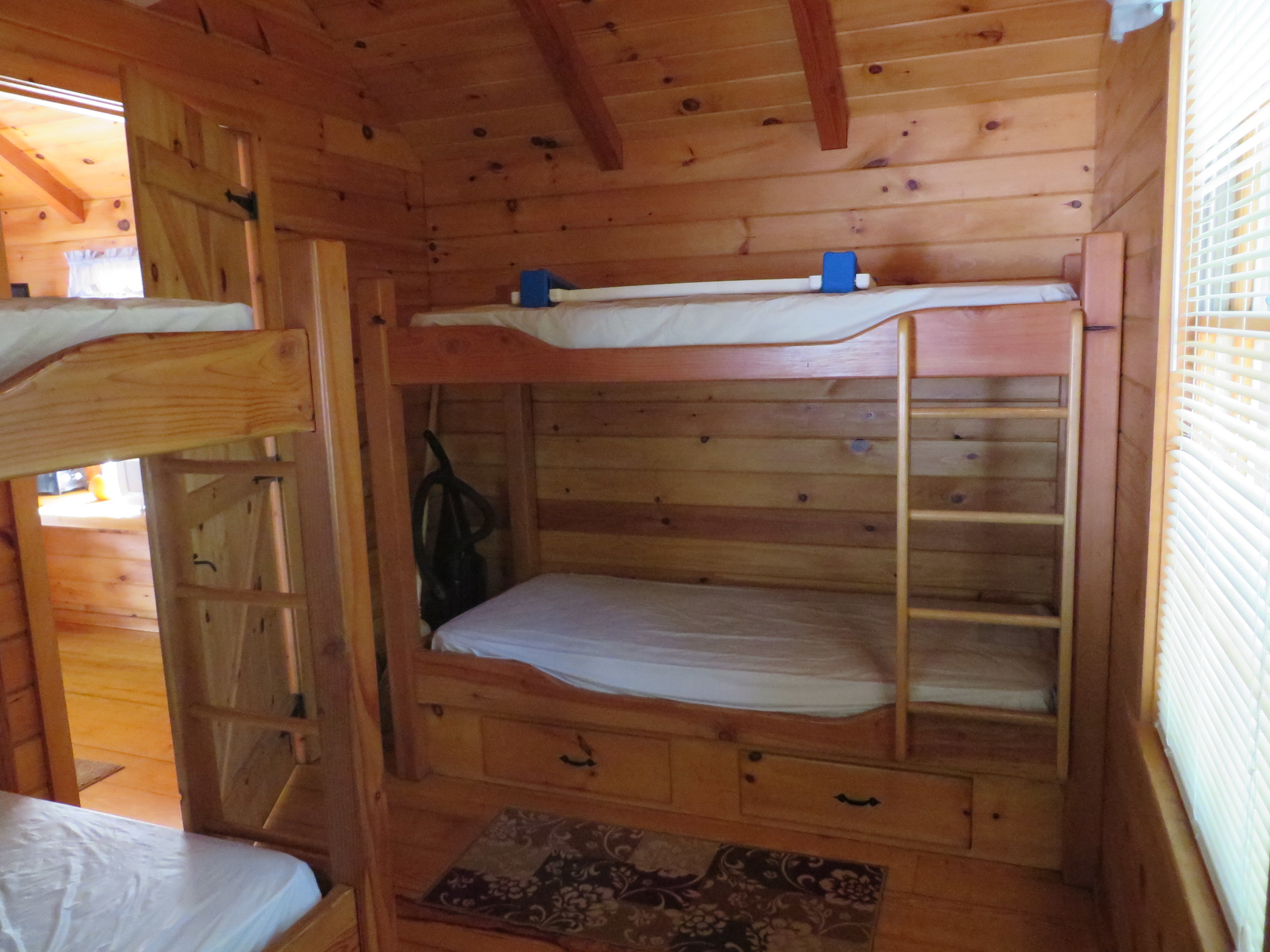 four bunk beds in back area of cabin