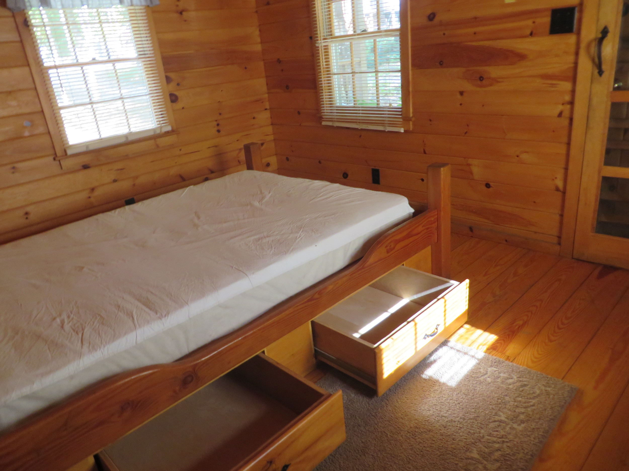 master bed and storage in cabin