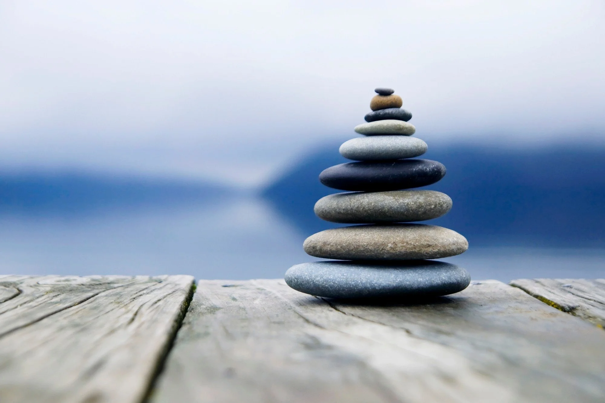 zen-balancing-pebbles-misty-lake_53876-138198.jpeg