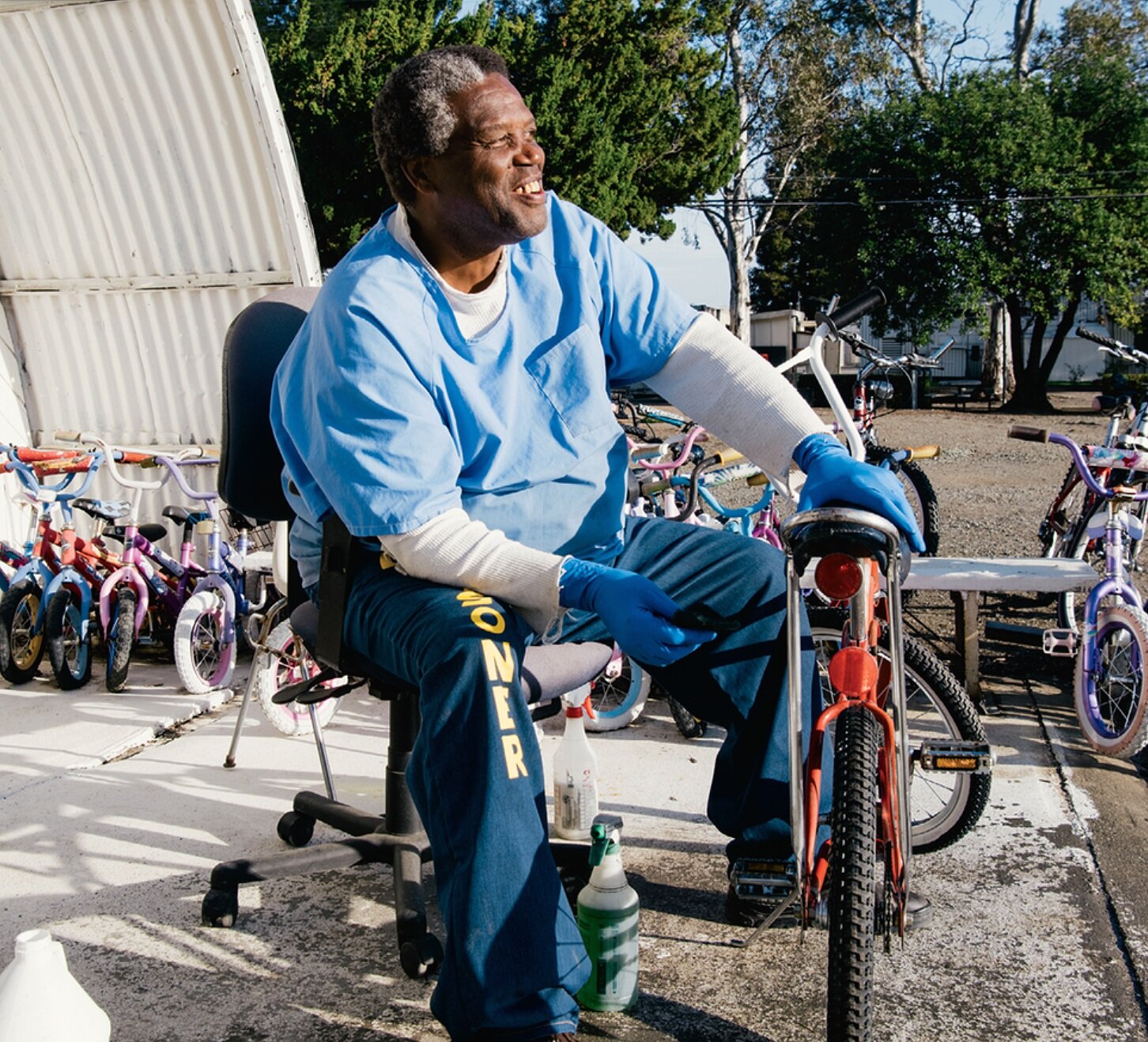 Incarcerated man fixing bicycle in prison