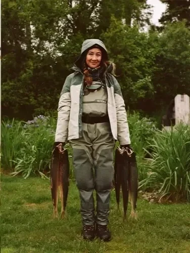 Kim Cross, author, holding five wild sockeye salmon caught on the Kwichak River in Alaska