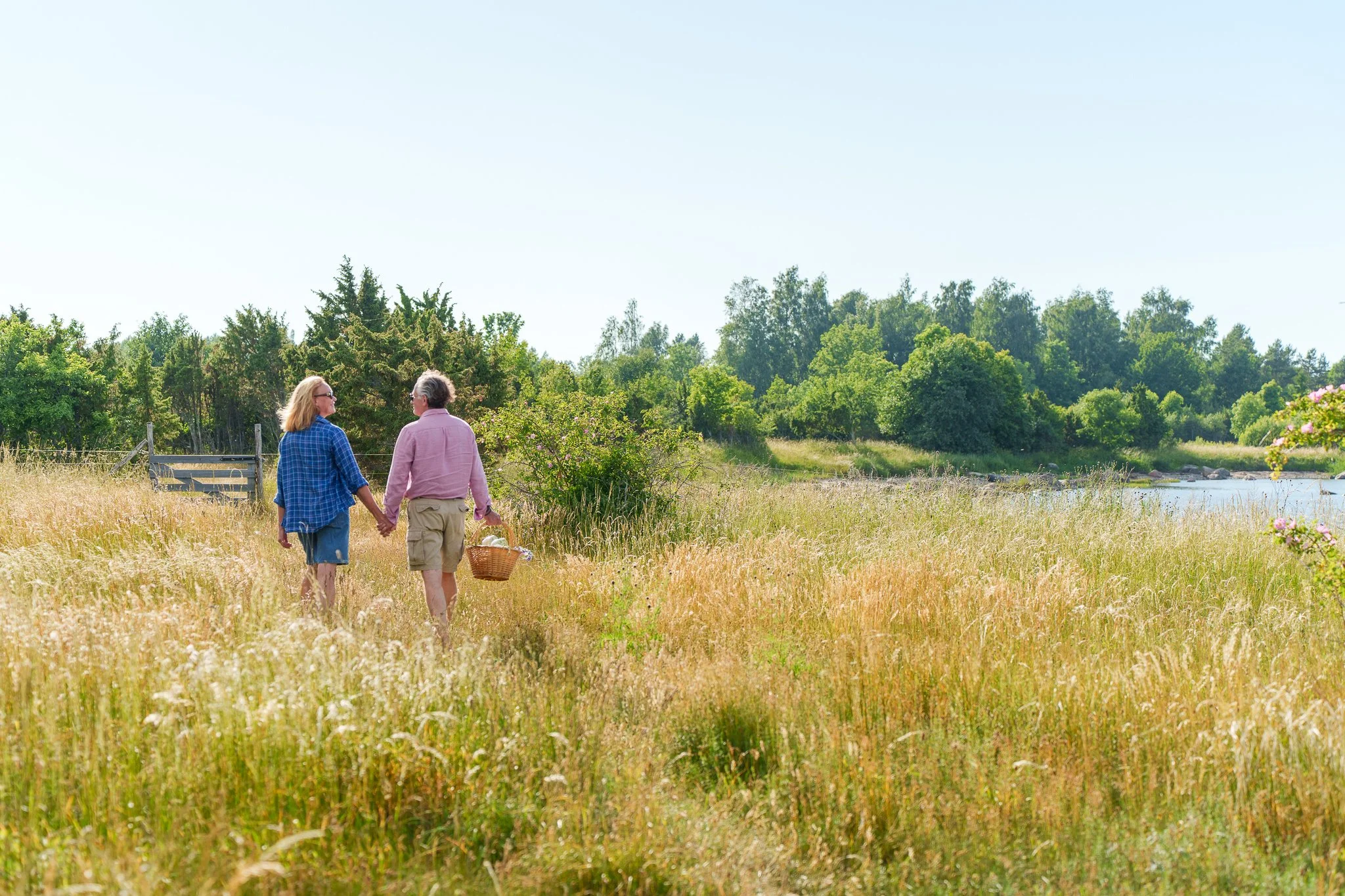 middle aged couple walking on the beach in tall grass on the island of Muhu, Estonia
