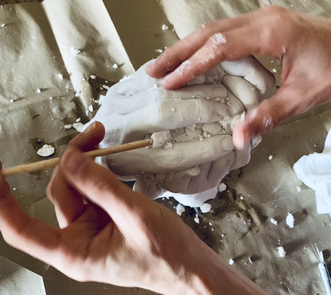 Removing the rubber mold to reveal the solid stone.