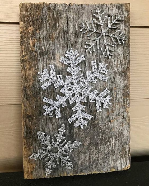 03-a-reclaimed-wood-piece-with-string-art-silver-snowflakes-looks-very-cool.jpg