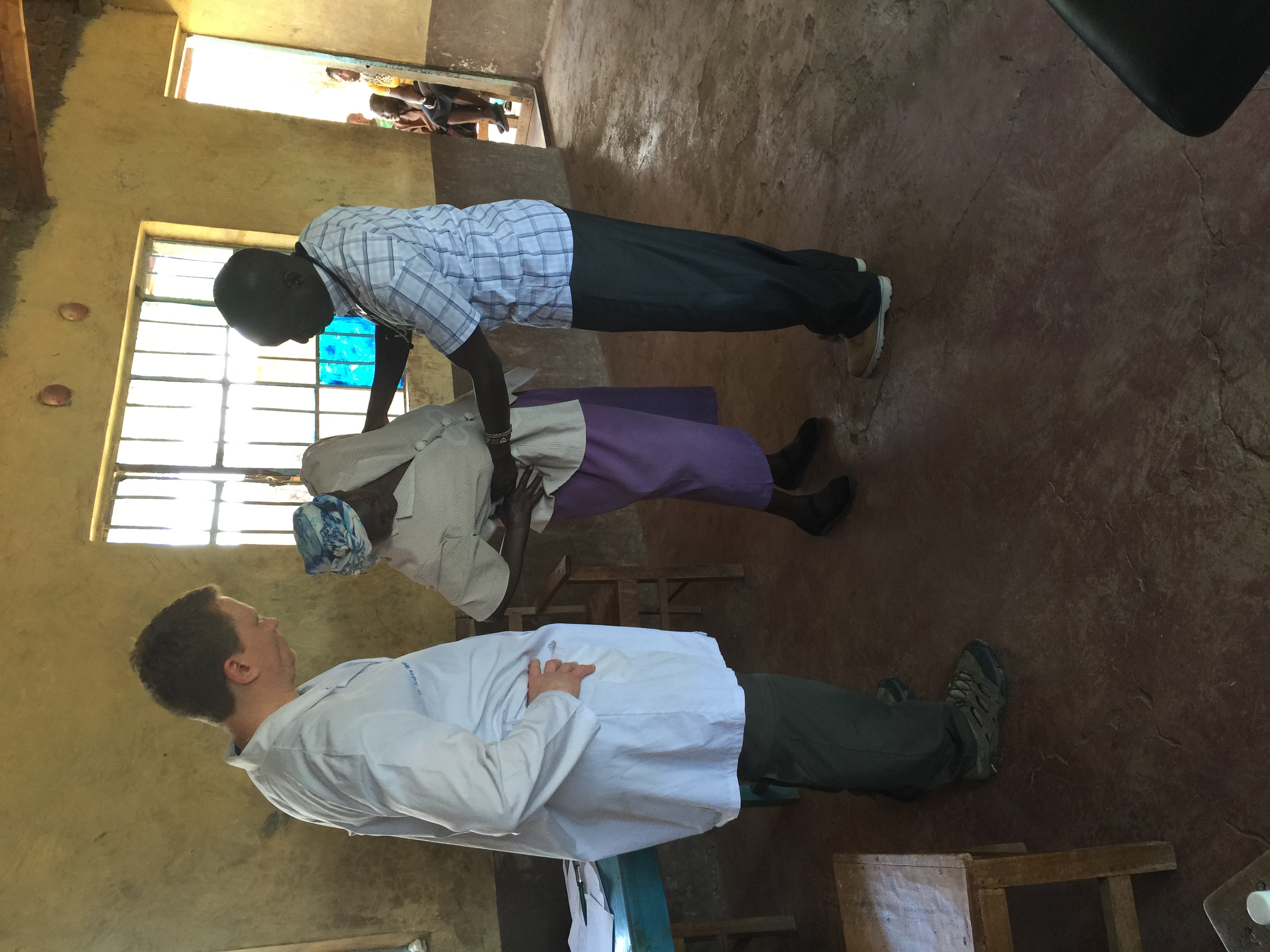 Dr. Miners and Samuel with a patient