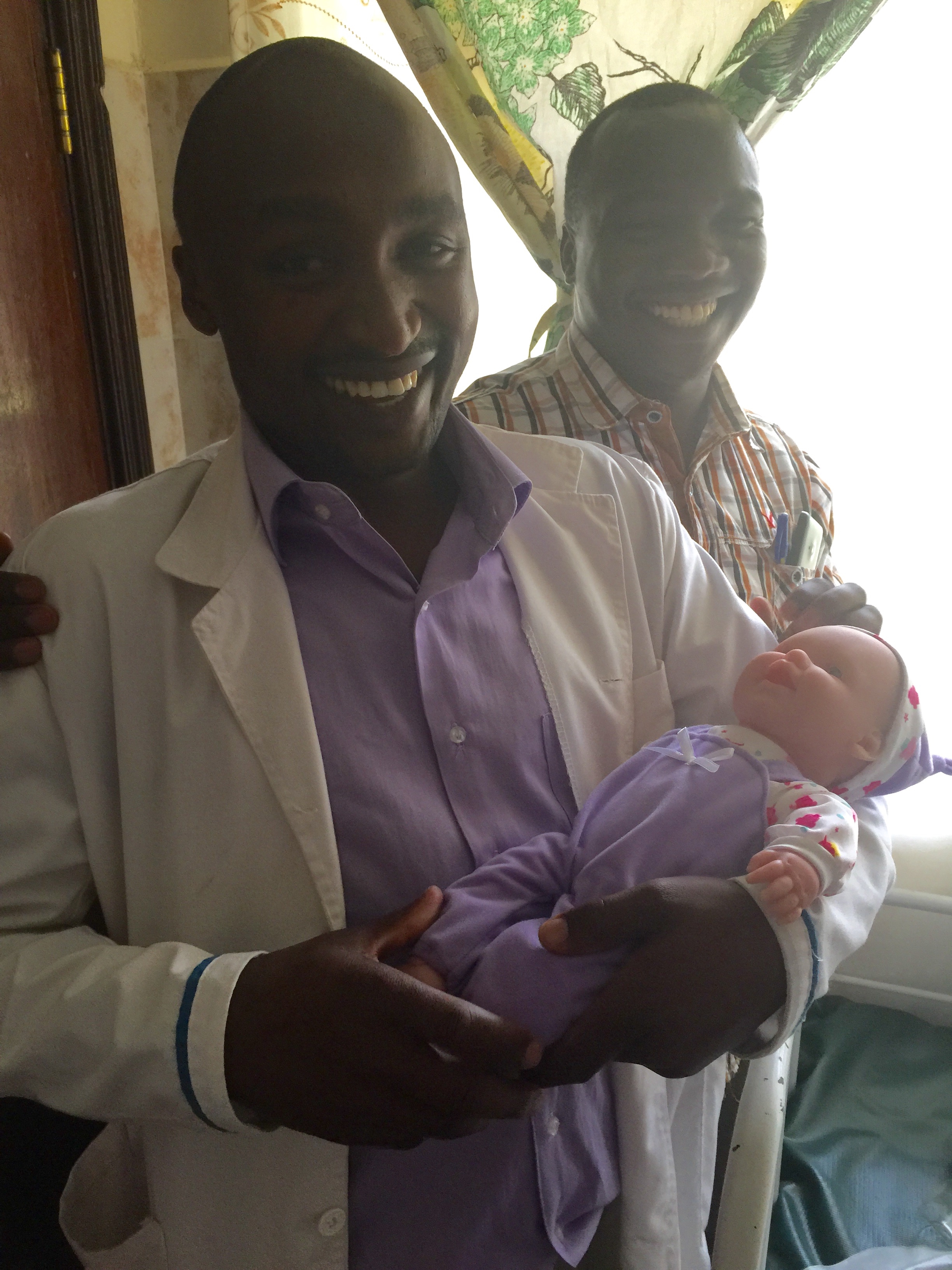  A fun moment with clinical officers Julius and Noah who are holding the baby prop for the Helping Babies Breathe course.&nbsp; 