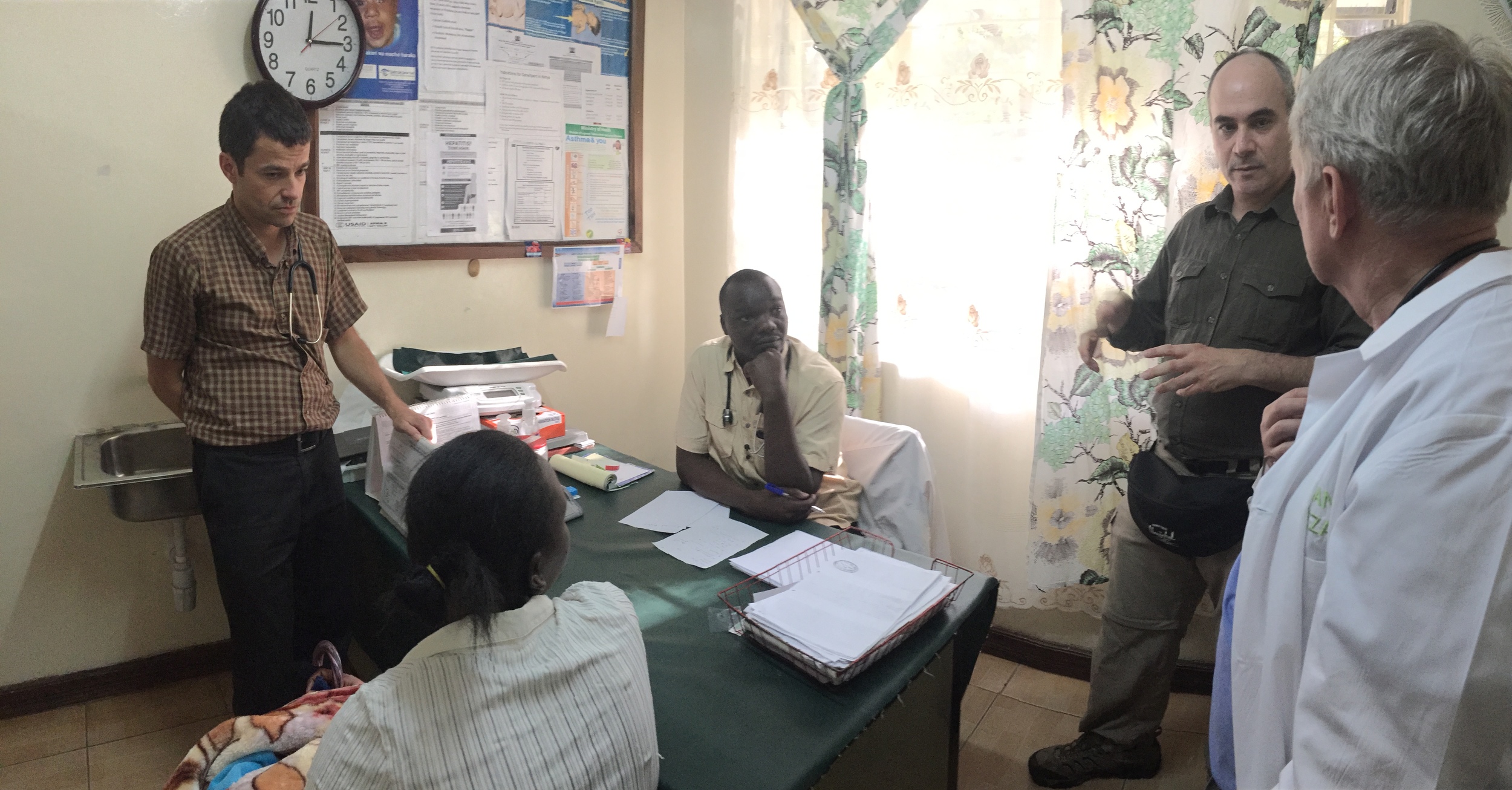Dr. Paul with Dr. Michael and Dr. Ed with Julius, the clinic manager, and a dermatology patient