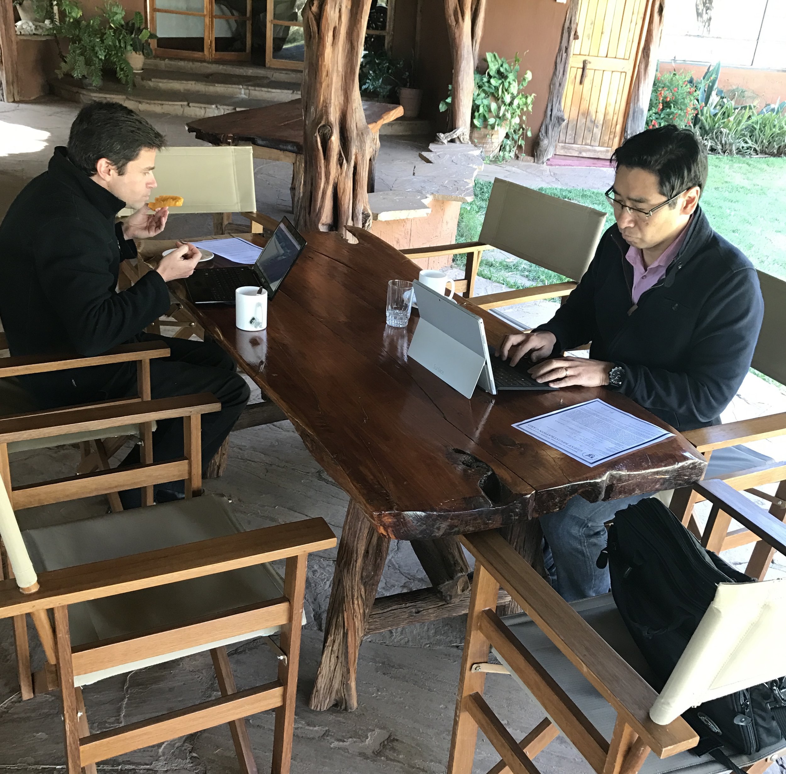 Dr. Michael and Dr. James working on their presentations after breakfast.