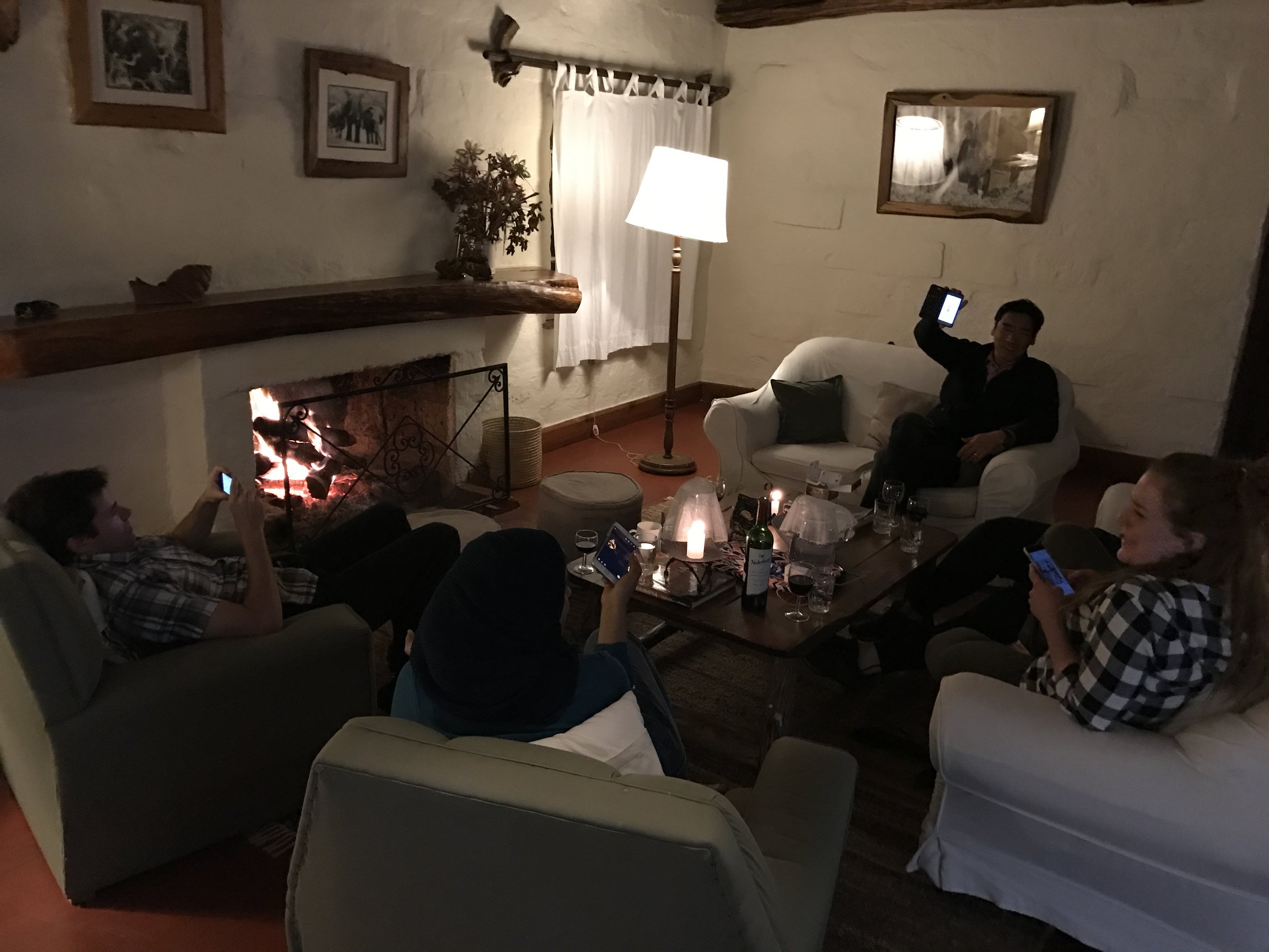  Sharing photos around the fire after dinner. 