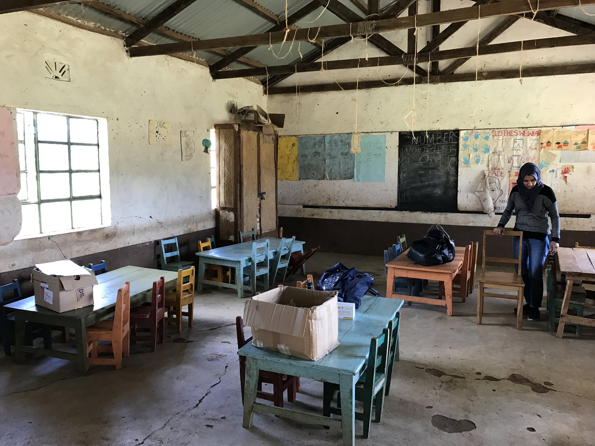  Dr. Sidiqa readying the classroom for the vision clinic. 