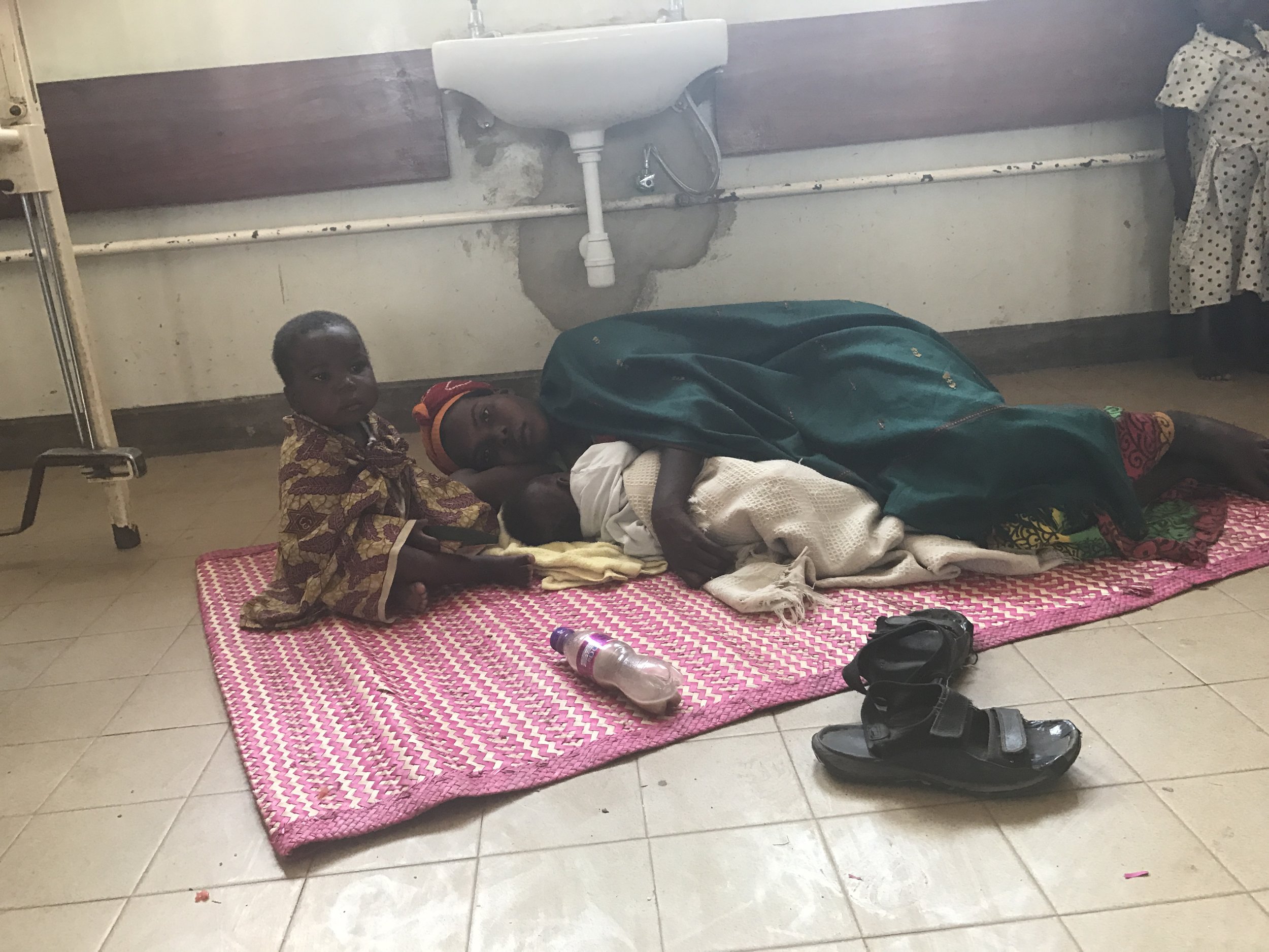  A tired mother with her sick child and newborn. I always ask if I can take these photos and all of the Ugandans are very gracious in allowing me to take pictures. 