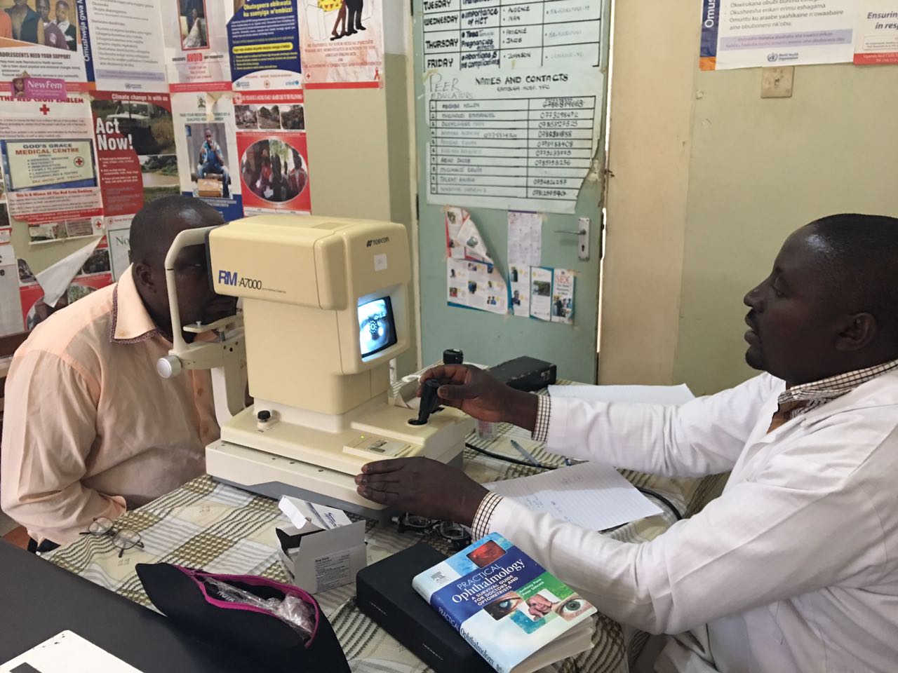  Alex using the auto refractor we've donated to the hospital. The auto refractor measures visual acuity in order to prescribe glasses. 