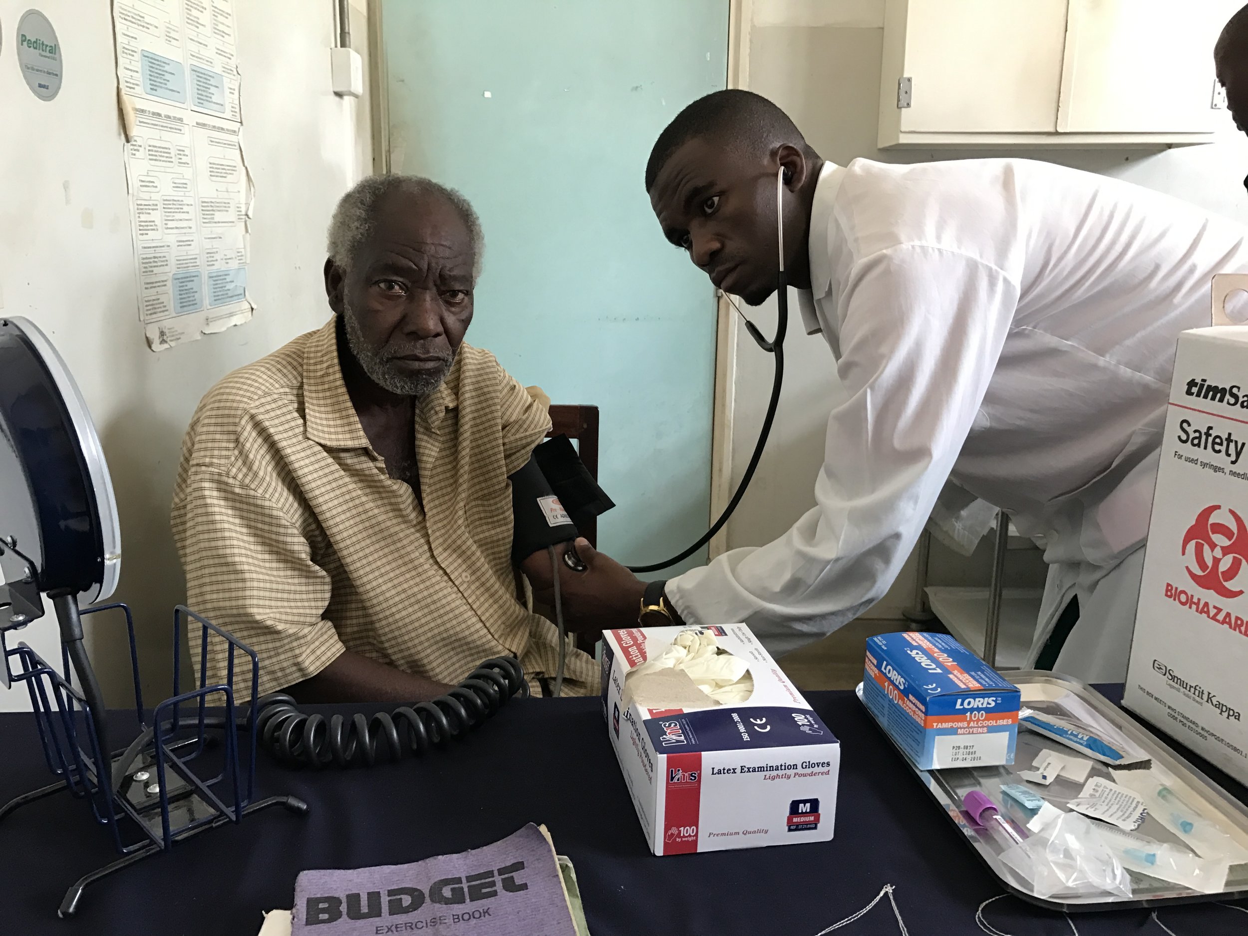 A chronic disease patient having his blood pressure taken.