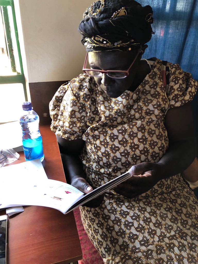 A patient tests out her new glasses to determine if her vision has improved. Naweza continued training on prescriptions for reading glasses and were able to give away 25 pairs this outreach. 
