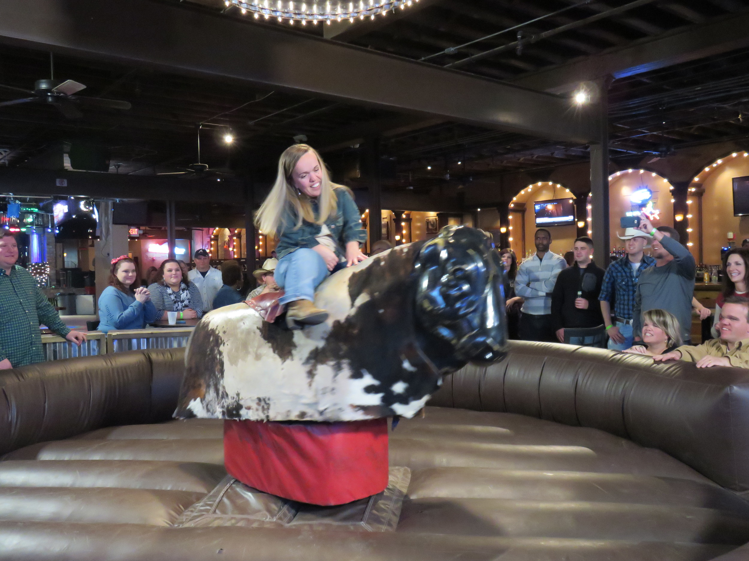   Amber attempting to ride the mechanical bull  