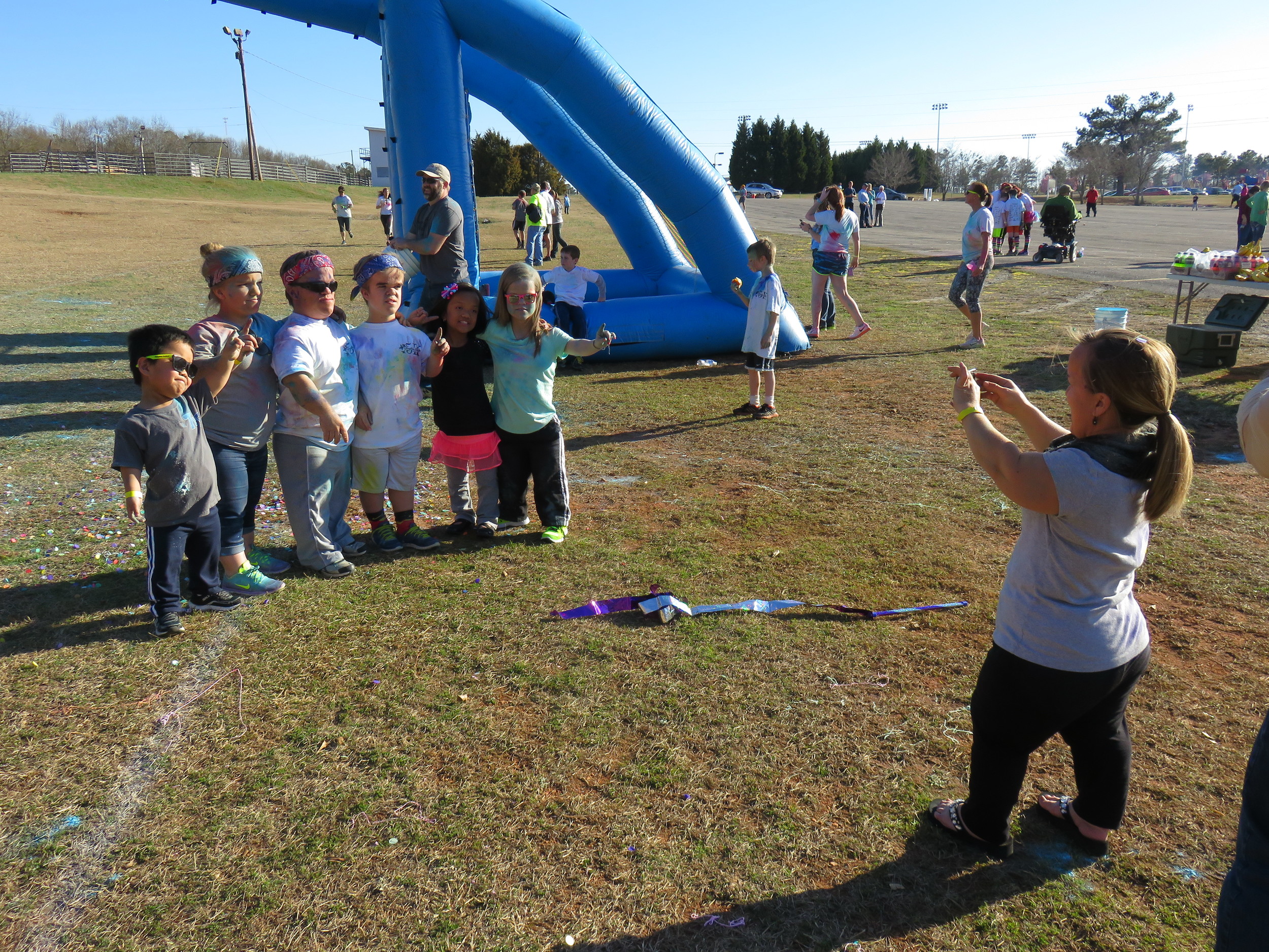 Amber takes a picture of the family at the Fun Run Finish Line