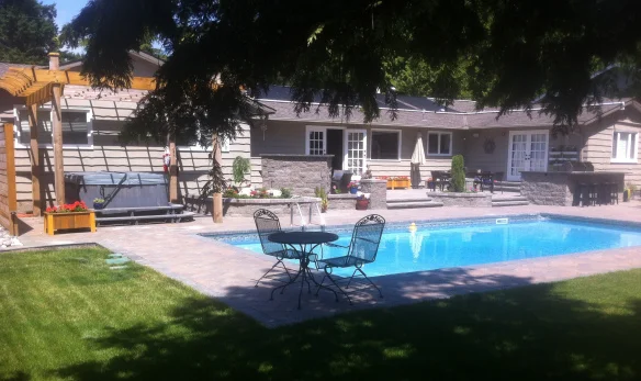 The rainwater storage system is underneath the grass lawn to the left of the pool!