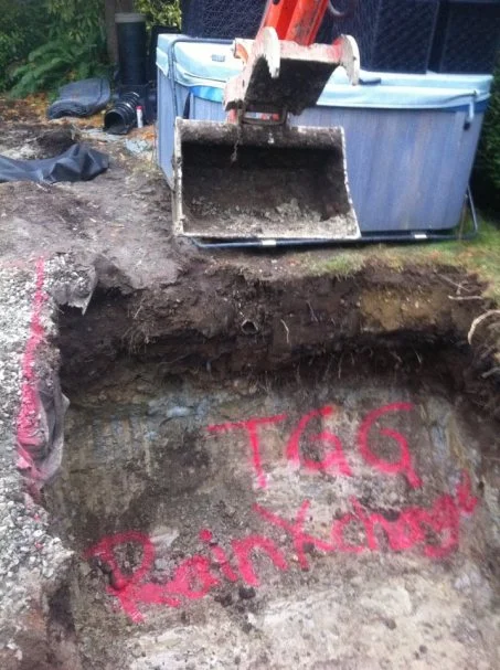 Excavating the pit for the drainage system.