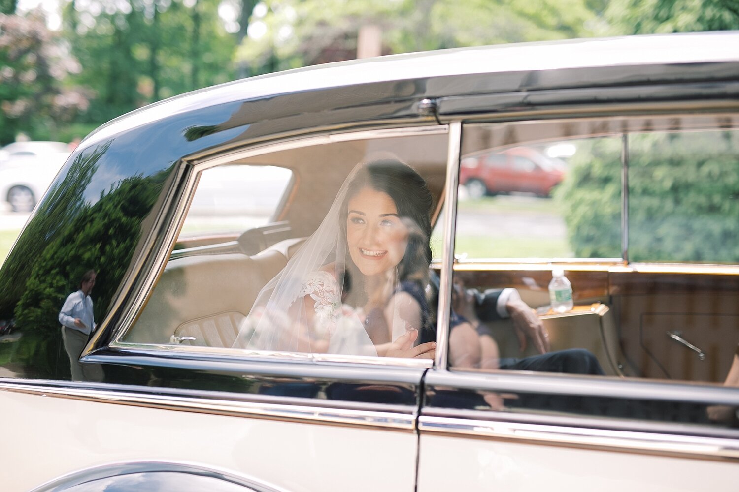 bride drives up to wedding ceremony in vintage car