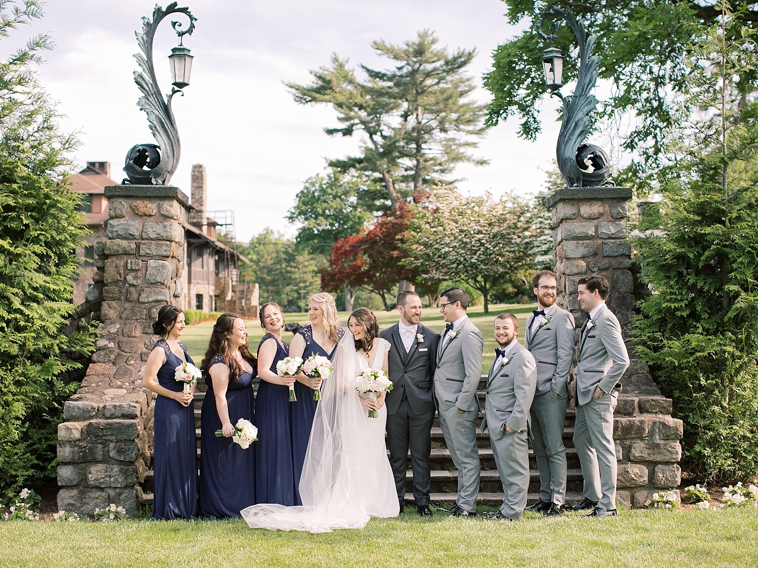 joyful bridal party portraits in Paramount Country Club gardens
