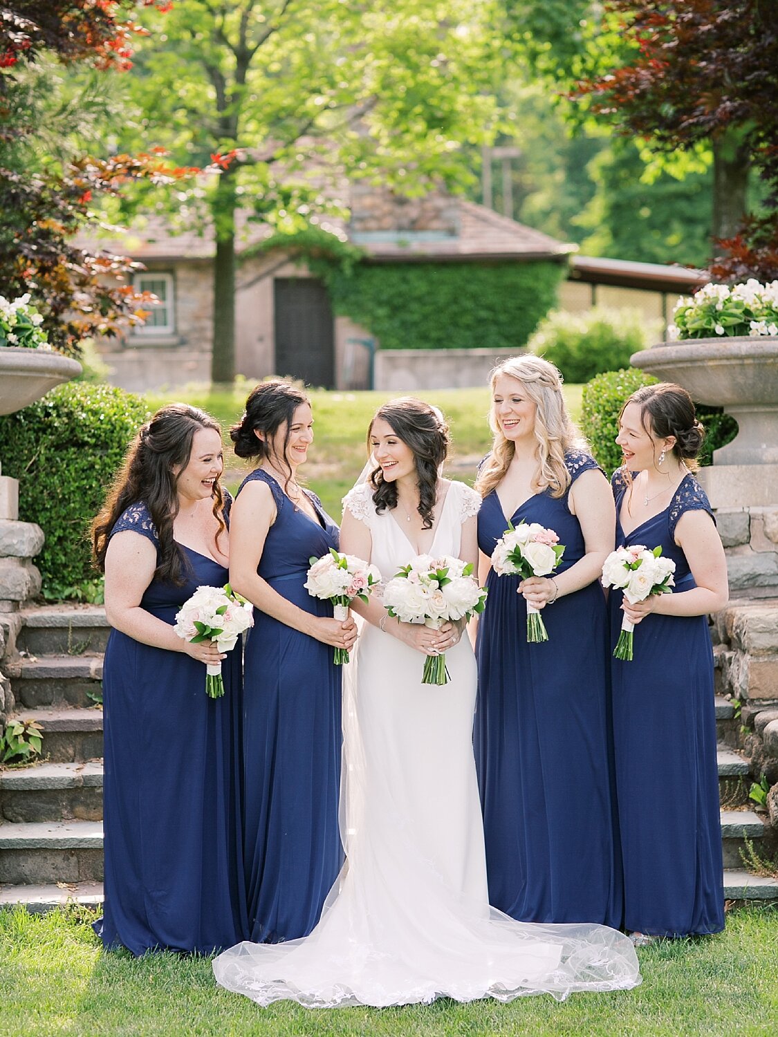 bride and bridesmaids in navy gown photographed by Asher Gardner Photography