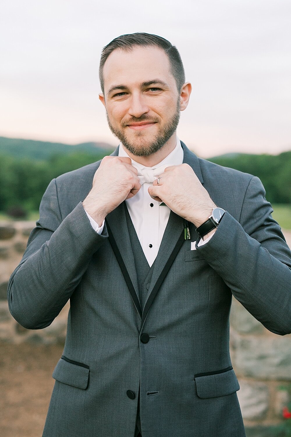 groom adjusts tie before Paramount Country Club wedding